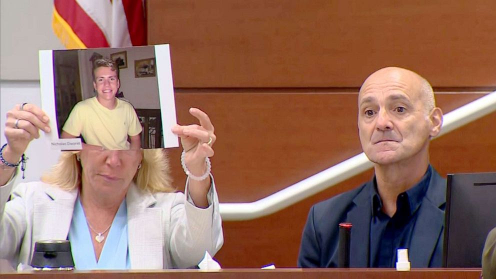 PHOTO: Mitch and Annika Dworet display a photo of their son Nicholas Dworet while giving their victim impact statements during the penalty phase of the trial of shooter Nikolas Cruz at the Broward County Courthouse in Fort Lauderdale, Fla., Aug. 2, 2022.