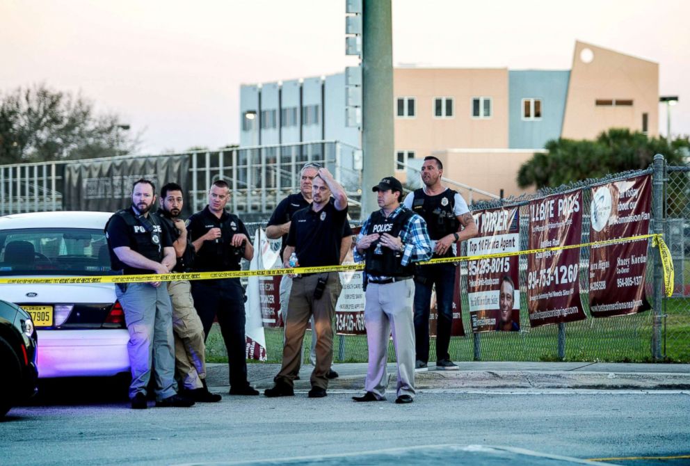 PHOTO: A group of police officers stand guard in front of the side entrance of the Marjory Stoneman Douglas High School after a shooting in Parkland, Fla., Feb. 14, 2018.