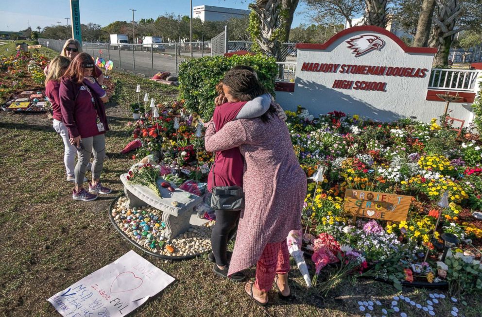 PHOTO: People visit a makeshift memorial in front of the Marjory Stoneman Douglas High School in, Parkland, Fla., Feb. 14 2019, on the one-year anniversary of the shooting.