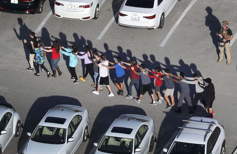 PHOTO: Students are brought out of the Marjory Stoneman Douglas High School after a shooting at the school that reportedly killed and injured multiple people on Feb. 14, 2018, in Parkland, Fla.