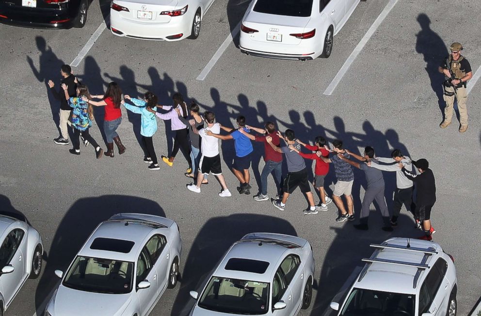 PHOTO: Students are brought out of the Marjory Stoneman Douglas High School after a shooting at the school on Feb. 14, 2018, in Parkland, Fla. 