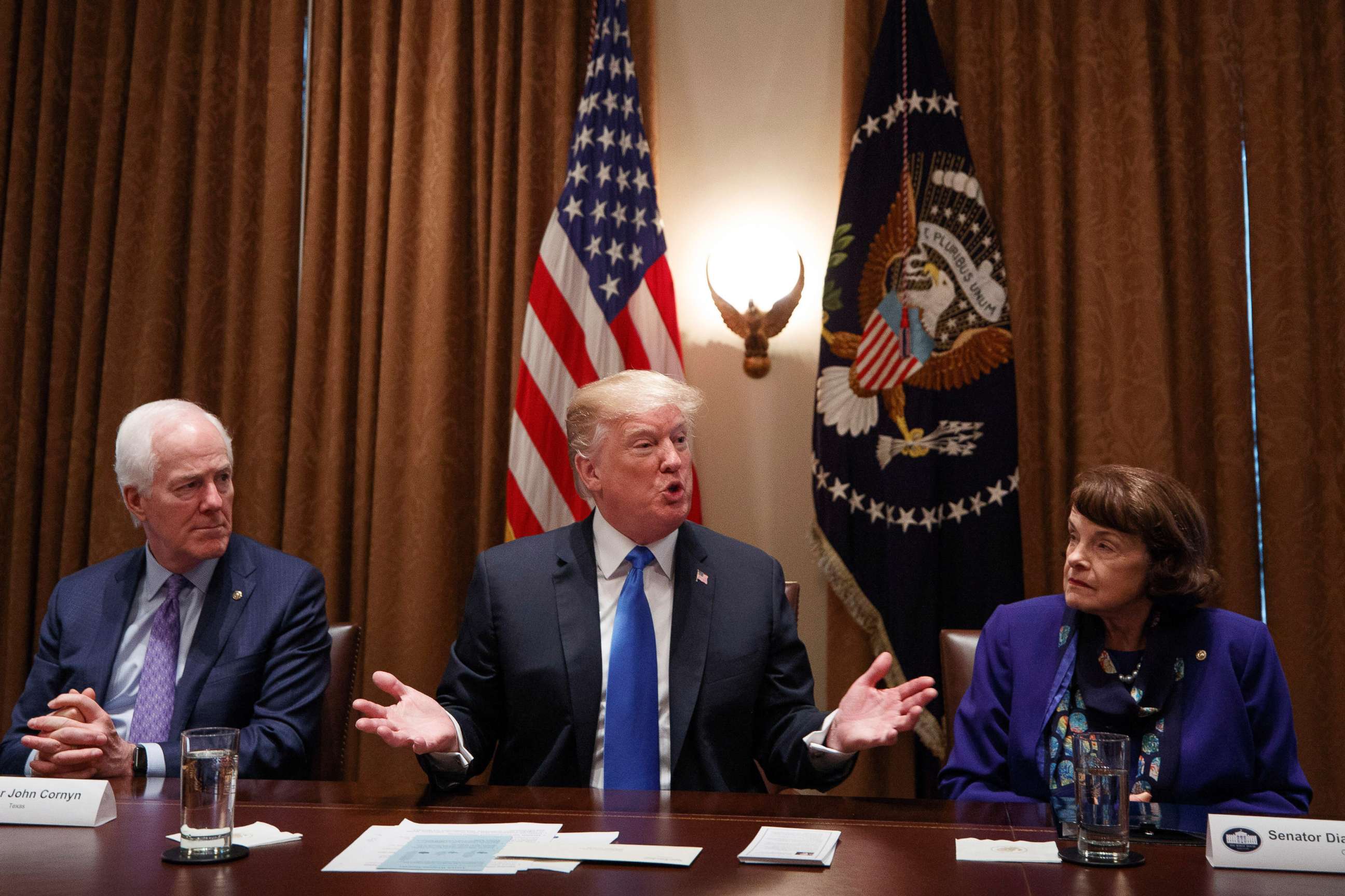 PHOTO: Sen. John Cornyn, left and Sen. Dianne Feinstein, right listen to President Donald Trump speak during a bipartisan round-table discussion on gun control, at the White House, Feb. 28, 2018. 