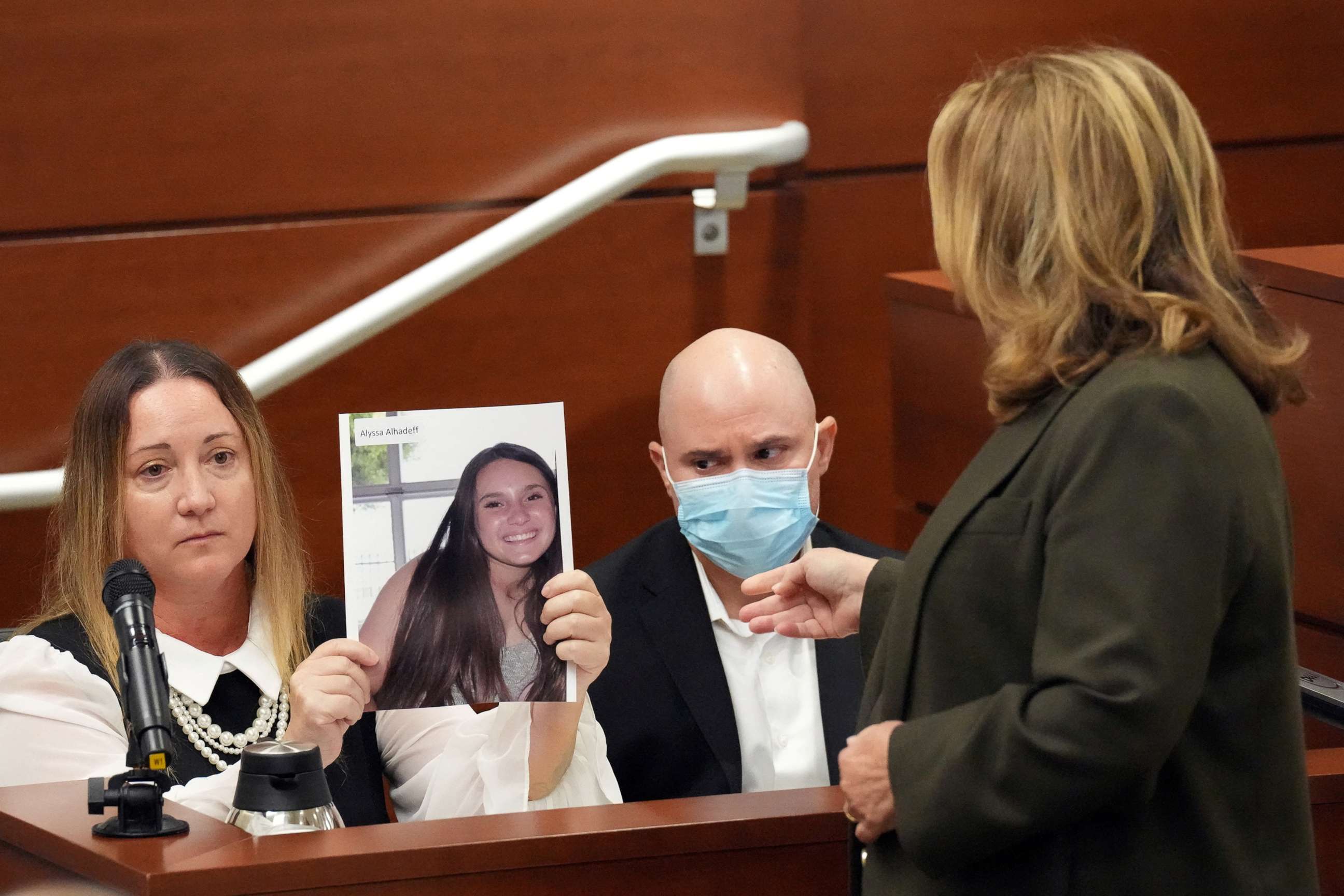 PHOTO: Lori Alhadeff holds a photograph of her daughter, Alyssa, as she and her husband, Ilan Alhadeff, take the stand to give their victim impact statements during the penalty phase of the trial of in Fort Lauderdale, Aug. 2, 2022.