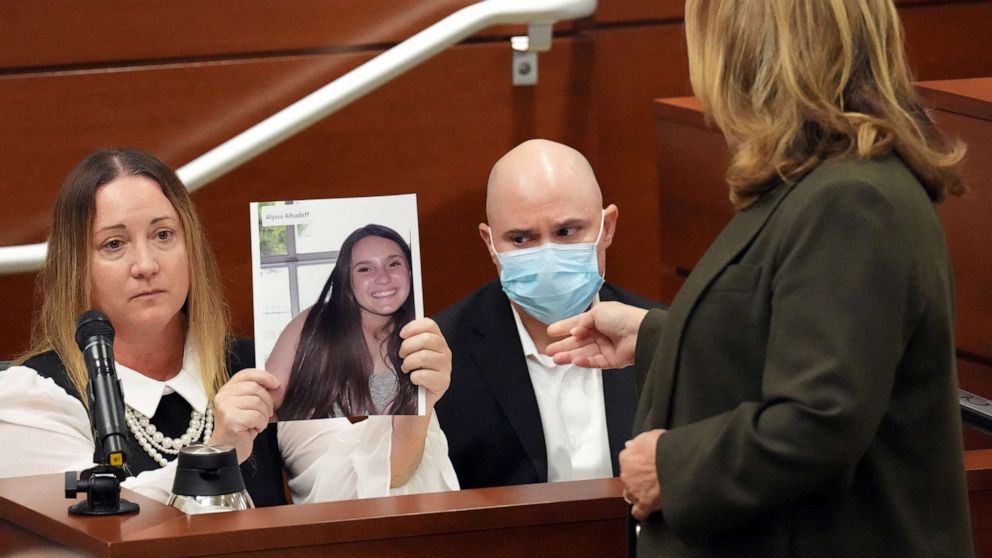 PHOTO: Lori Alhadeff holds a photograph of her daughter, Alyssa, as she and her husband, Ilan Alhadeff, take the stand to give their victim impact statements during the penalty phase of the trial of in Fort Lauderdale, Aug. 2, 2022.