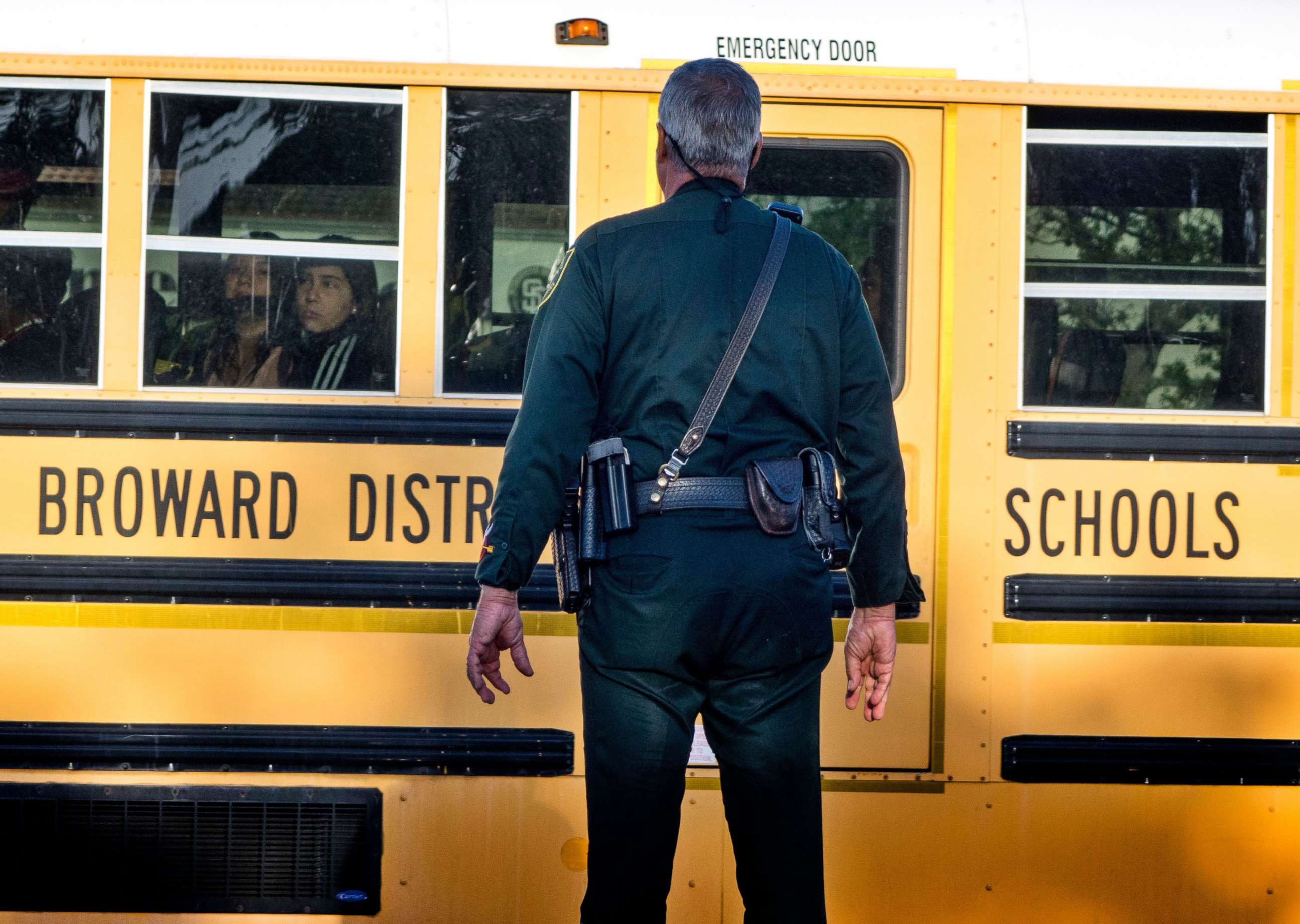 PHOTO: A police officer on duty the Marjory Stoneman Douglas High School entrance as parents and students arrive at the High School in Parkland, Fla.  Feb.28, 2018, for the school's reopening, two weeks after the mass shootings at the school.