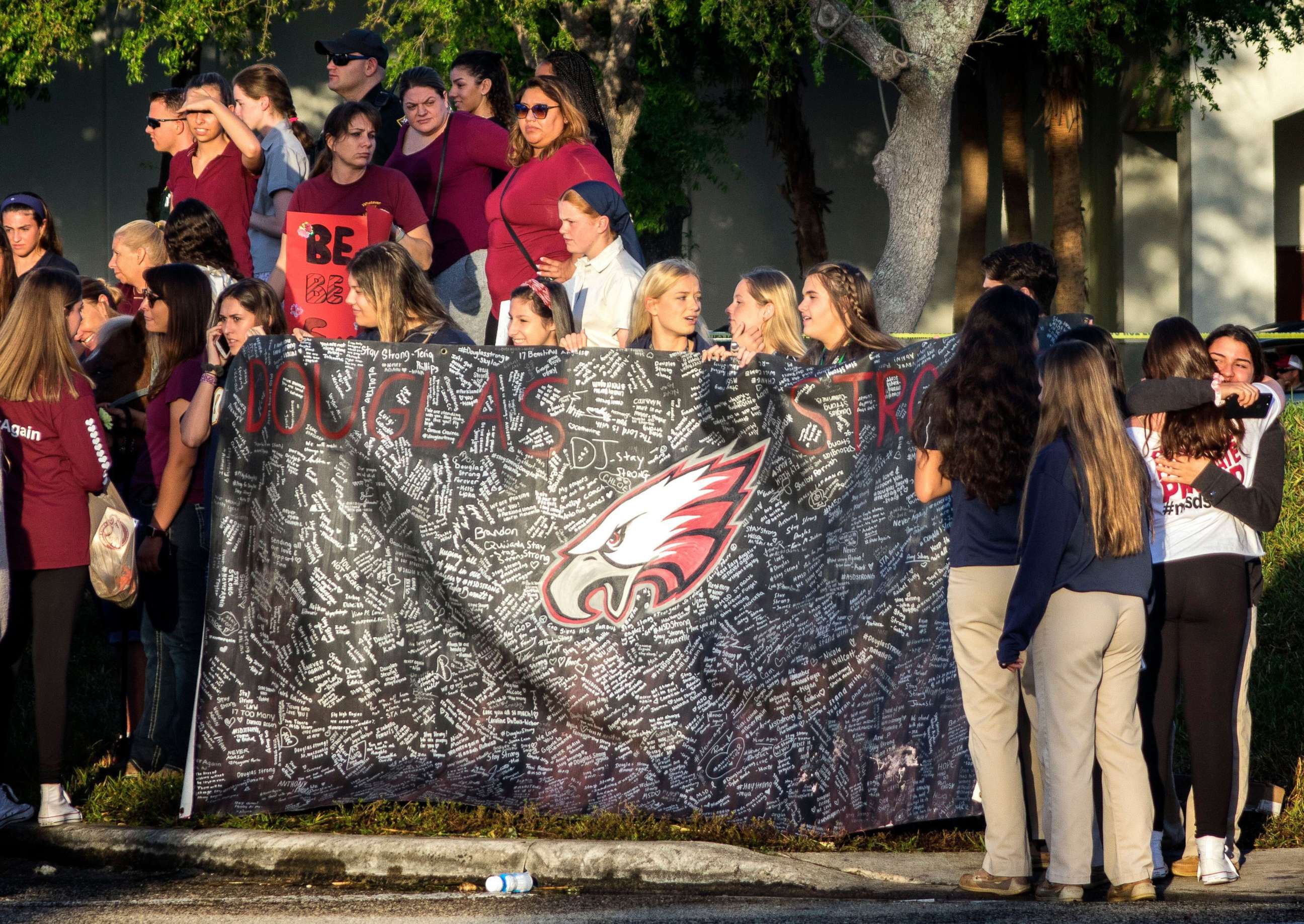 PHOTO: A banner bearing messages is held as parents and students arrive at Marjory Stoneman Douglas High School in Parkland, Fla., Feb. 28, 2018, for the school's reopening, two weeks after the mass shootings at the school.