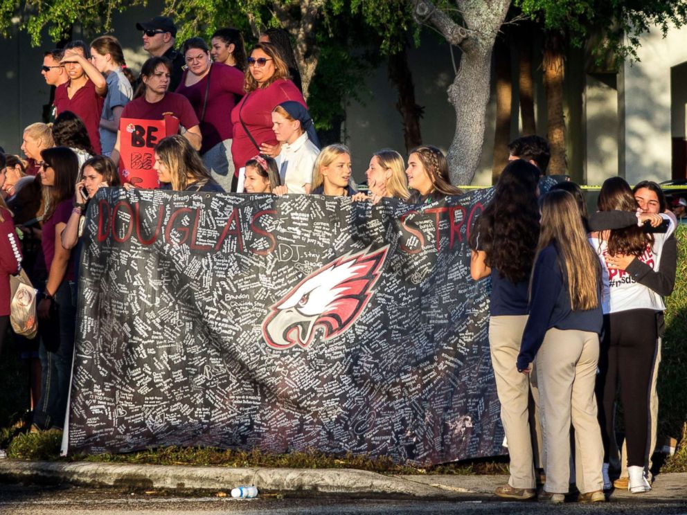 PHOTO: A banner bearing messages is held as parents and students arrive at Marjory Stoneman Douglas High School in Parkland, Fla., Feb. 28, 2018, for the schools reopening, two weeks after the mass shootings at the school.