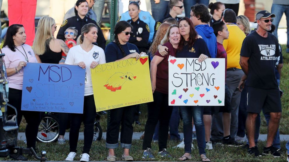 PHOTO: Supporters hold signs as students head back to classes at Marjory Stoneman Douglas High School in Parkland, Fla., Feb. 28, 2018.