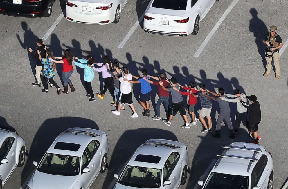 PHOTO: People are brought out of the Marjory Stoneman Douglas High School after a shooting at the school, Feb. 14, 2018 in Parkland, Fla.
