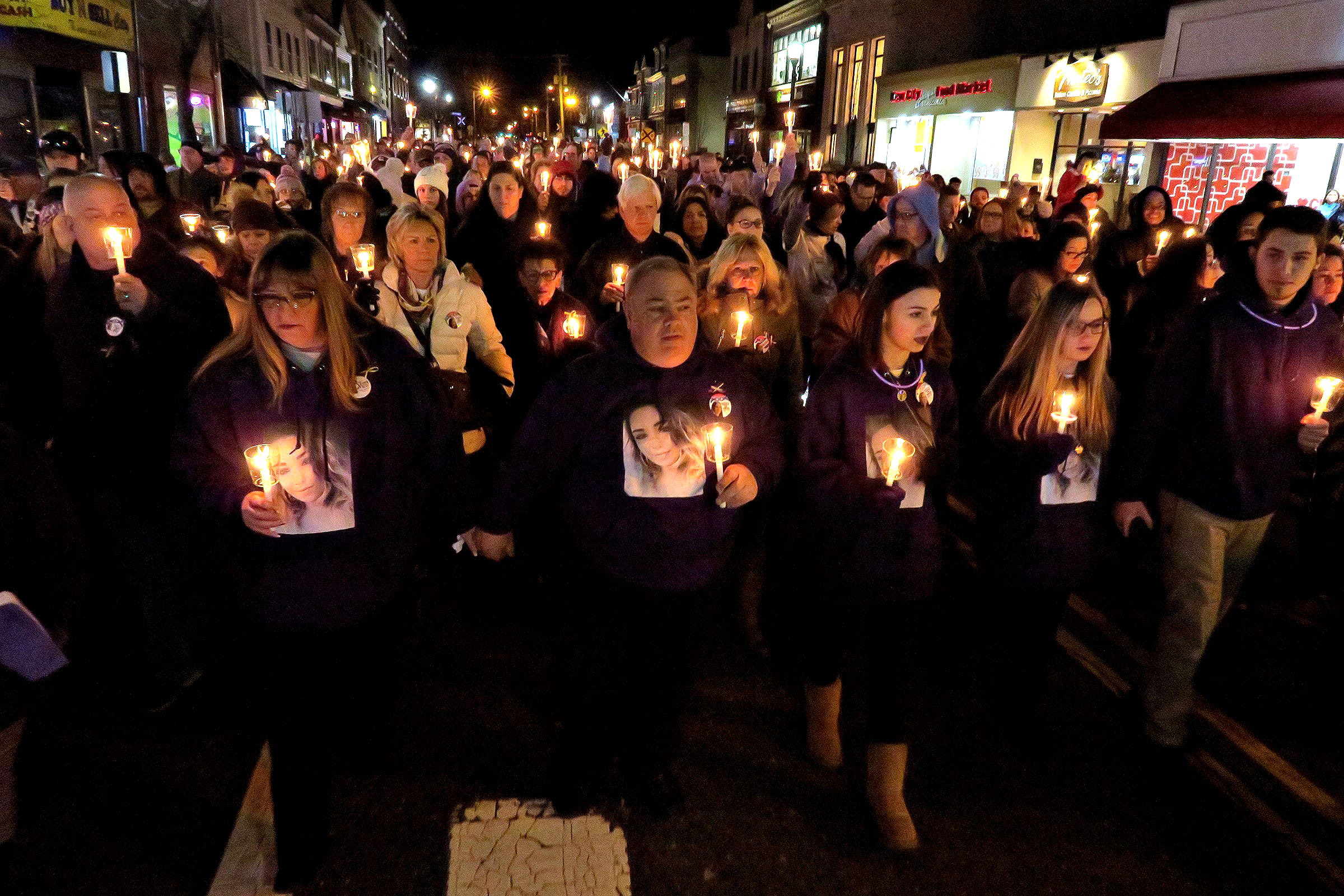 PHOTO: Ed and Sharlene Parze are joined by other family members and hundreds of people as they walk along West Front Street in Freehold Borough for a memorial service for their daughter Stephanie Parze, Feb. 19, 2020.