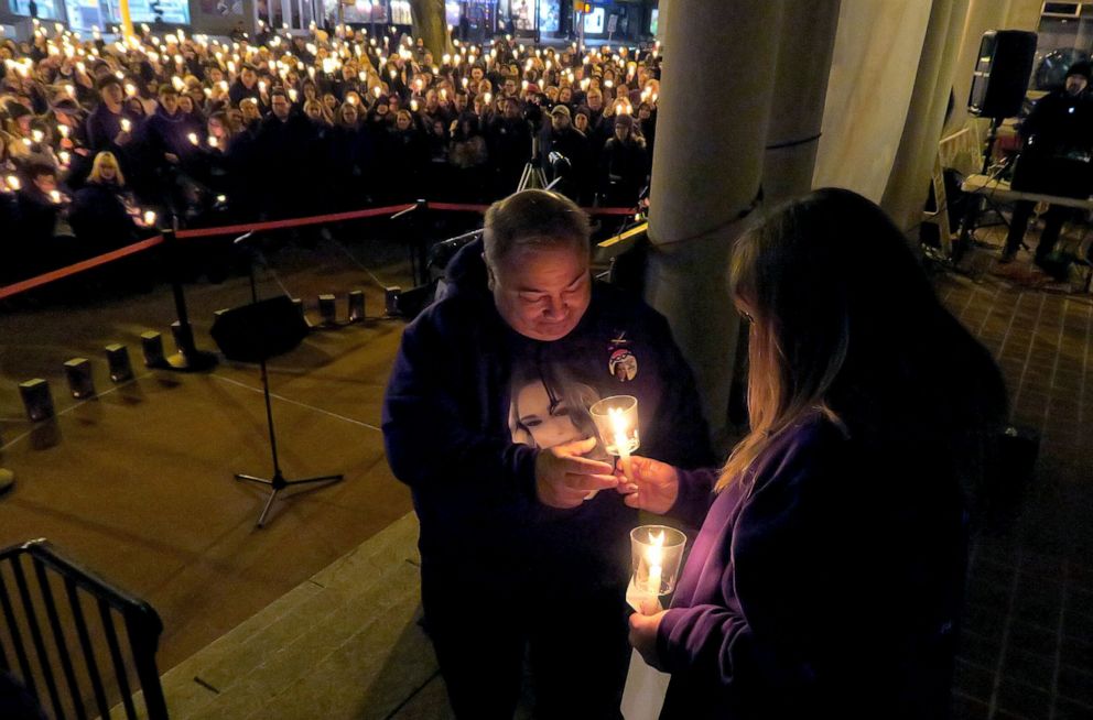 PHOTO: Ed Parze, takes a candle from his wife Sharlene during the memorial for their daughter, Stephanie Parze, with people gathered outside the Monmouth County Hall of Records in Freehold Borough, Feb. 19, 2020. 