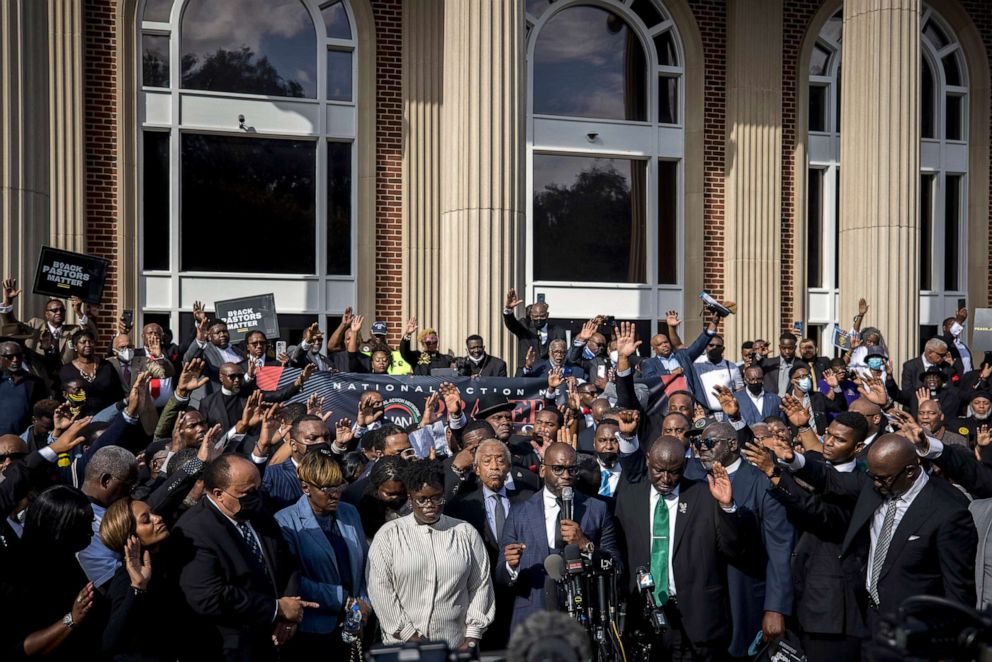 PHOTO: Pastor Jamal Bryant, bottom center, leads a group prayer for to nearly 750 pastors, supporters and family of Ahmaud Arbery gathered outside the Glynn County Courthouse Nov. 18, 2021, in Brunswick, Ga.