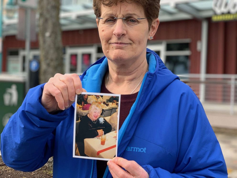 PHOTO: Pat Herrick holding up a picture of her mother after she passed in Kirkland, Washington.