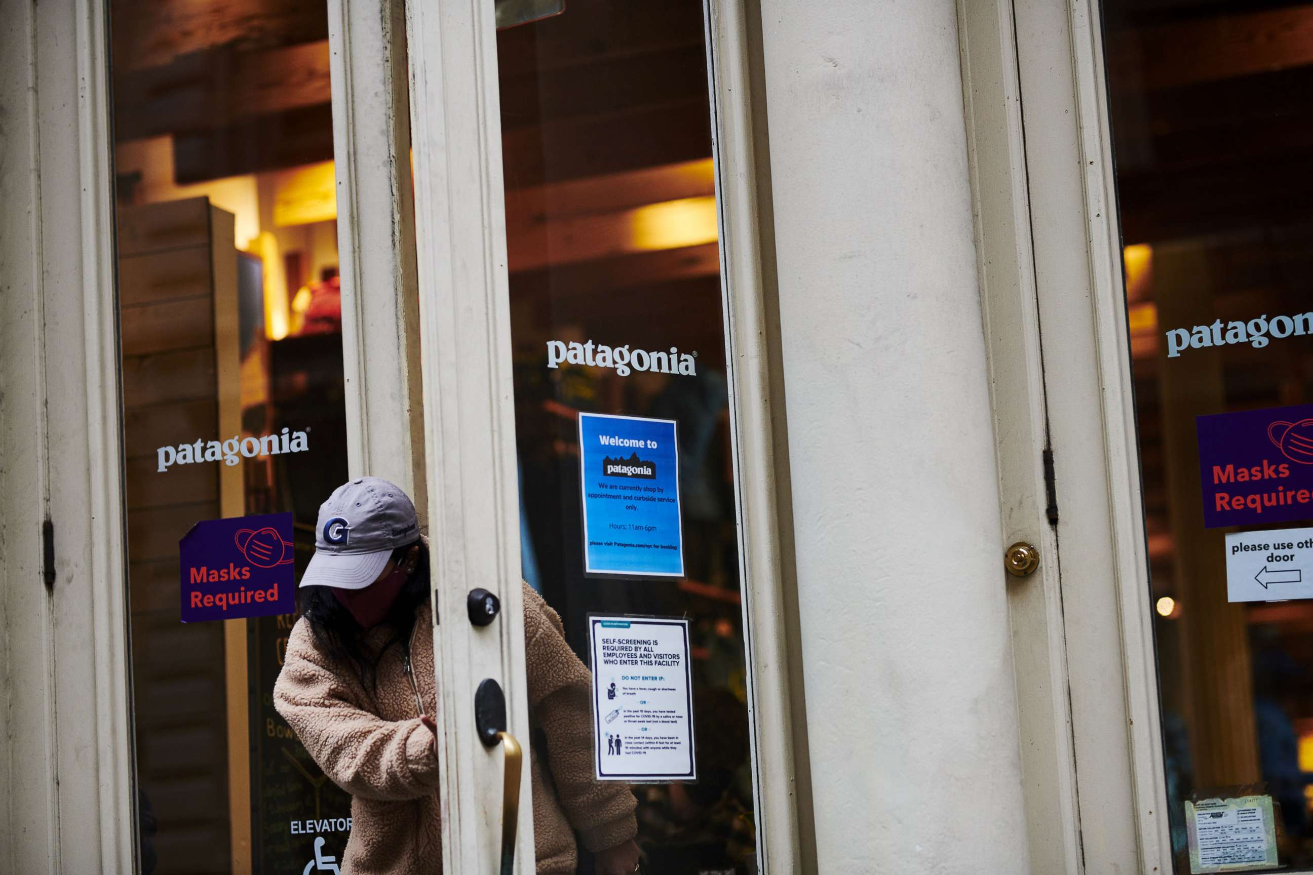 PHOTO: A customer exits a Patagonia Inc. store in the SoHo neighborhood of New York, Dec. 14, 2020. 