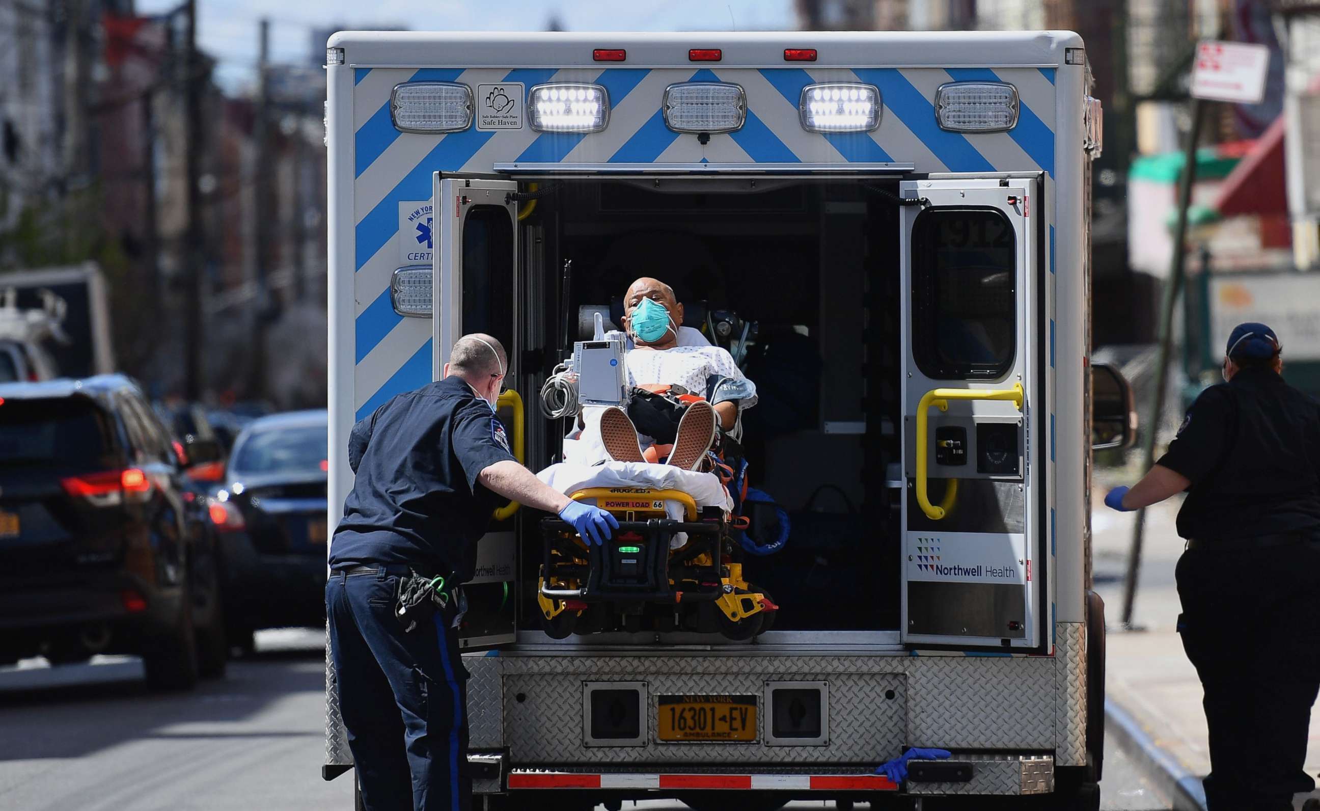 PHOTO: Paramedics transport a patient wearing a face mask to the emergency room entrance of the Wyckoff Heights Medical Center in the New York City borough of Brooklyn on April 2, 2020.