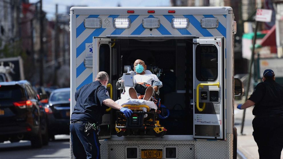 PHOTO: Paramedics transport a patient wearing a face mask to the emergency room entrance of the Wyckoff Heights Medical Center in the New York City borough of Brooklyn on April 2, 2020.