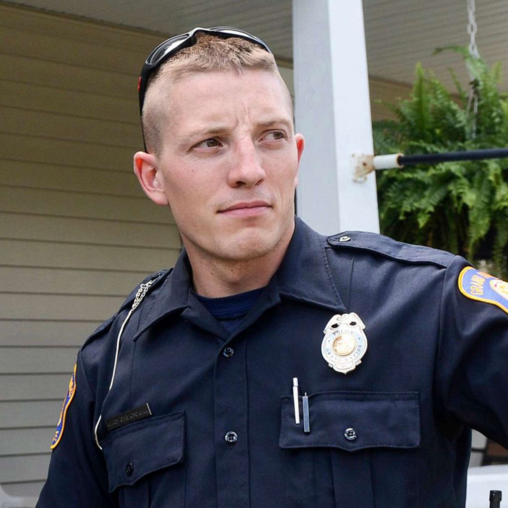 PHOTO: Police Officer Christopher Schurr stops to talk with a resident in Grand Rapids, Mich., Aug. 12, 2015. 