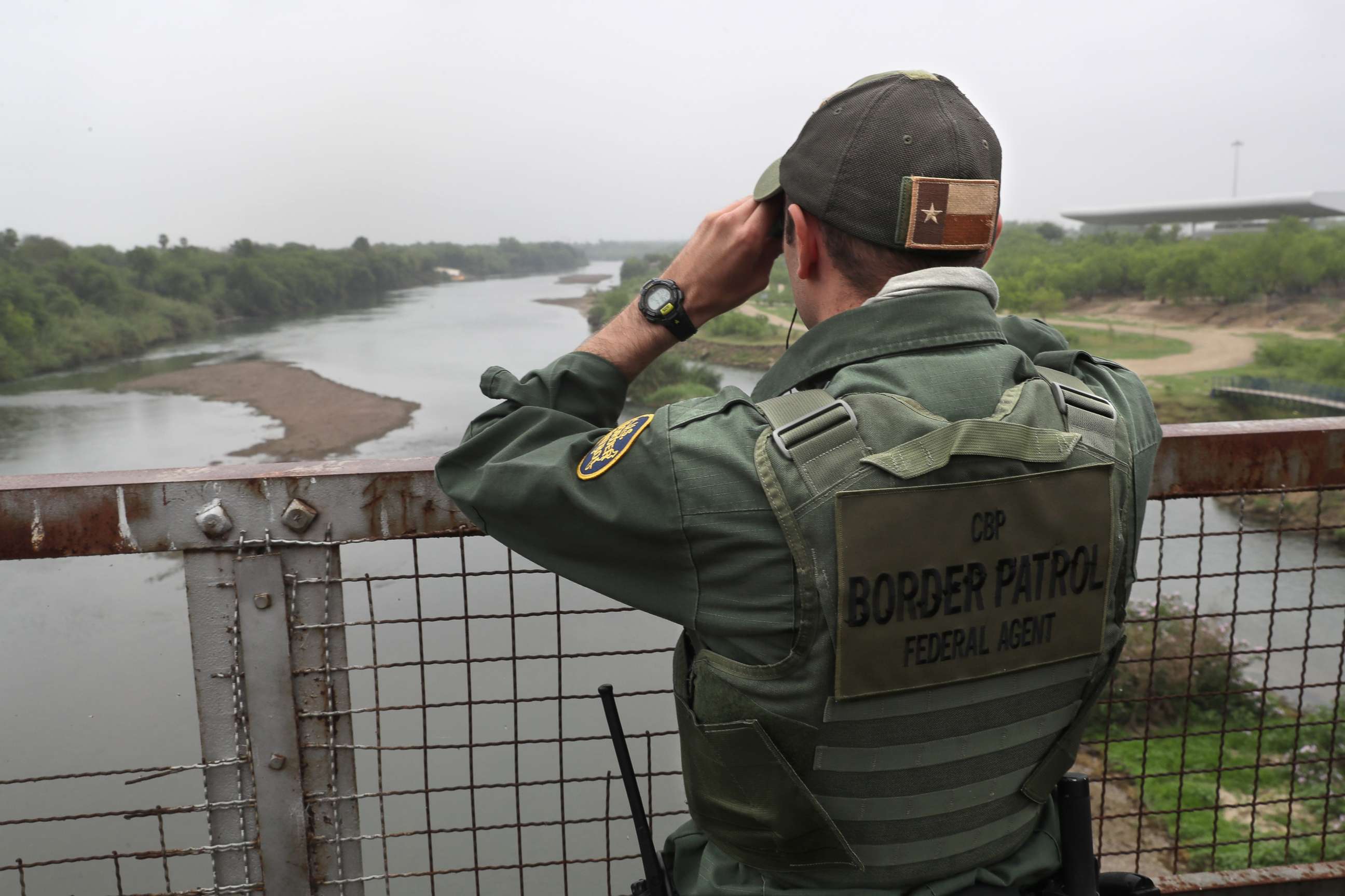 PHOTO: A U.S. Border Patrol agent scans the U.S.-Mexico border while on a bridge over the Rio Grande, March 13, 2017, in Roma, Texas
