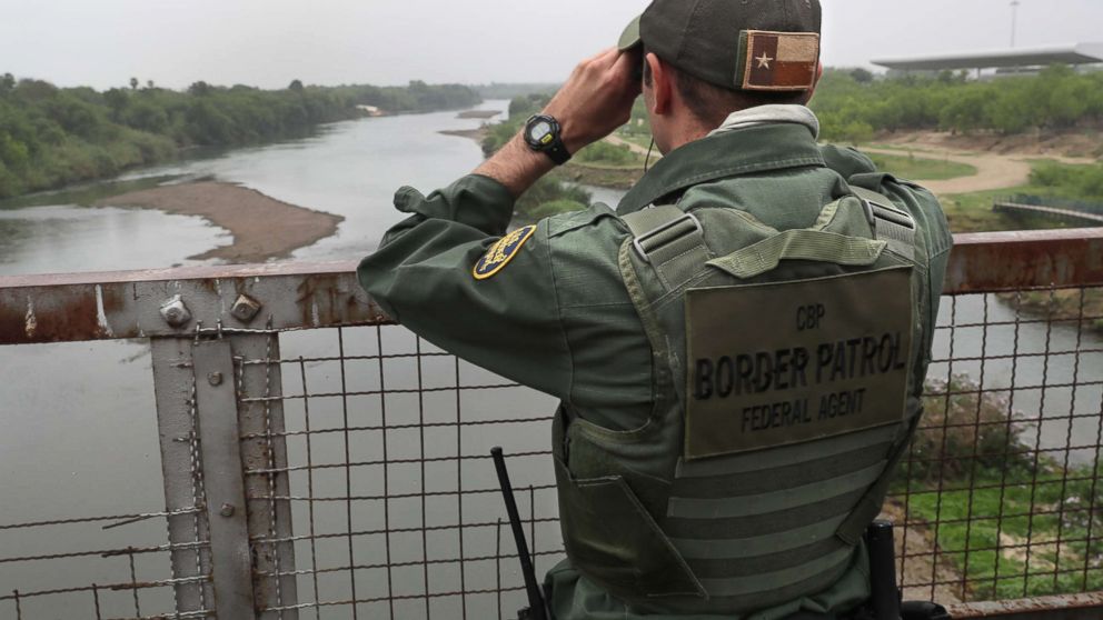 A U.S. Border Patrol agent scans the U.S.-Mexico border while on a bridge over the Rio Grande, March 13, 2017, in Roma, Texas.