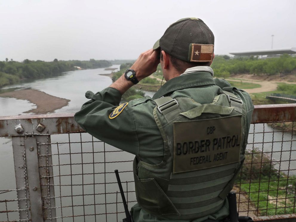 PHOTO: A U.S. Border Patrol agent scans the U.S.-Mexico border while on a bridge over the Rio Grande, March 13, 2017, in Roma, Texas
