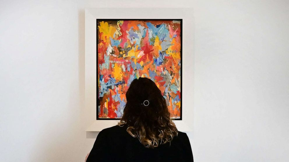 PHOTO: A woman views "Small False Start" by Jasper Johns on display at Christie's Los Angeles on October 12, 2022 in Beverly Hills, California during the media preview of "Visionary: The Paul Allen Collection."