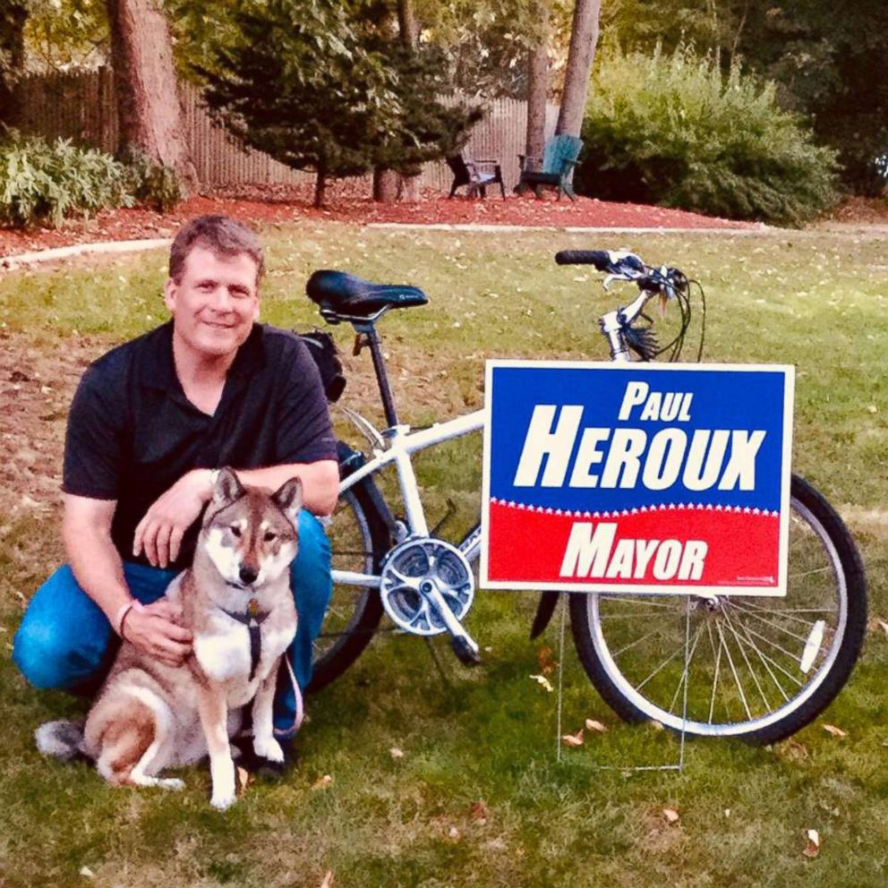 PHOTO: Paul Heroux sits by a campaign sign with Mura in an undated handout photo.