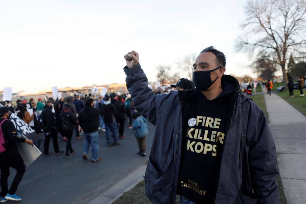 PHOTO: Gabriel 'Black' Elk holds up a fist while protesters march near the Brooklyn Center Police Department, as protests continue after former police officer Kim Potter fatally shot Daunte Wright, in Brooklyn Center, Minnesota, U.S. April 16, 2021.
