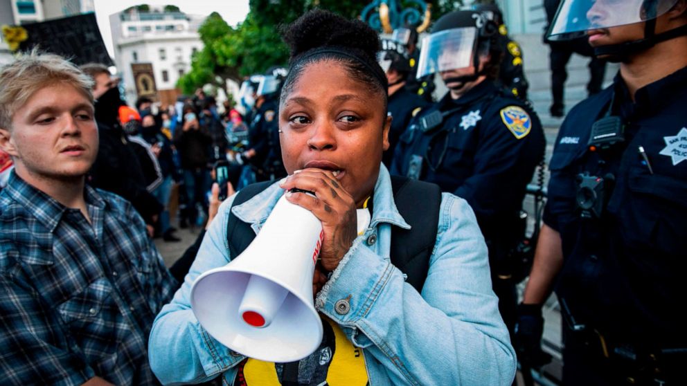 PHOTO: Marie Moroe of San Francisco, Calif., pleads with demonstrators to leave the scene before curfew, during a protest over the police killing of George Floyd, outside City Hall in San Francisco, May 31, 2020.