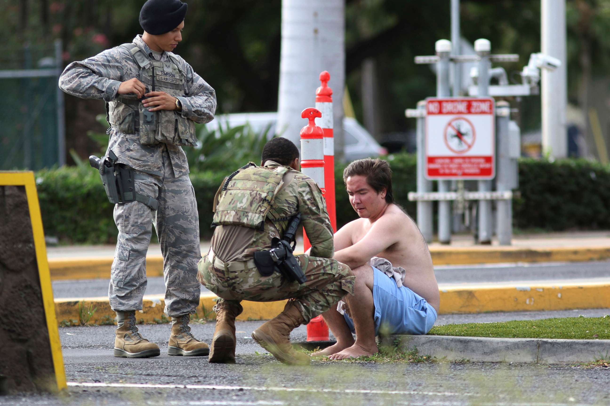 PHOTO: Security forces attend to an unidentified male outside the the main gate at Joint Base Pearl Harbor-Hickam, Dec. 4, 2019, in Hawaii, following a shooting.
