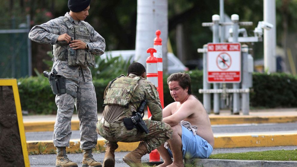 PHOTO: Security forces attend to an unidentified male outside the the main gate at Joint Base Pearl Harbor-Hickam, Dec. 4, 2019, in Hawaii, following a shooting.