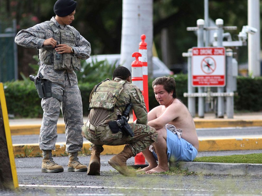 PHOTO: Security forces attend to an unidentified male outside the the main gate at Joint Base Pearl Harbor-Hickam, Dec. 4, 2019, in Hawaii, following a shooting.