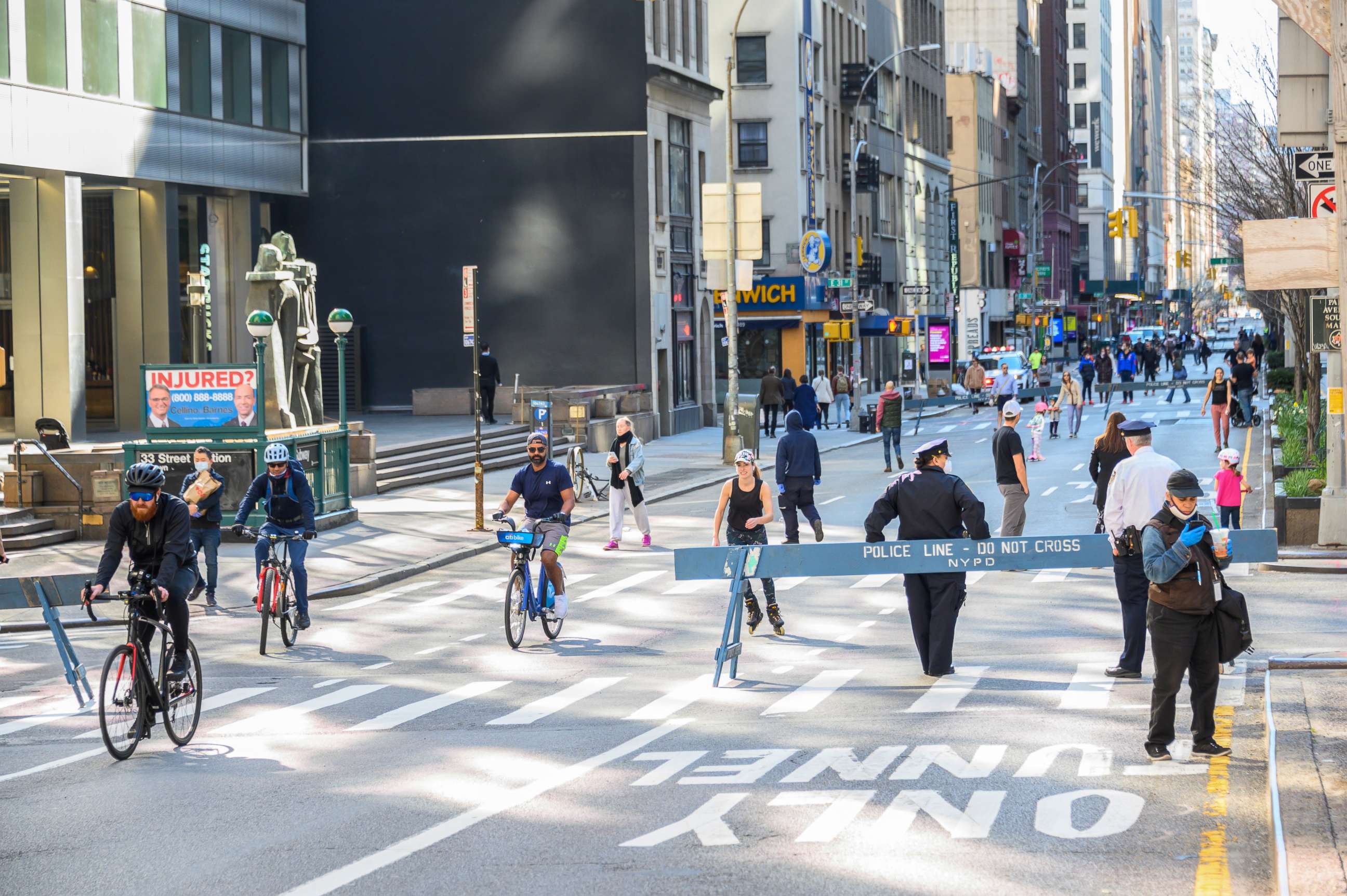 PHOTO: People are seen in Park Avenue as part of NYC's "Open Streets," which closes some streets to vehicle traffic to allow more space for pedestrians, as the coronavirus continues to spread across the United States on March 27, 2020 in New York City.