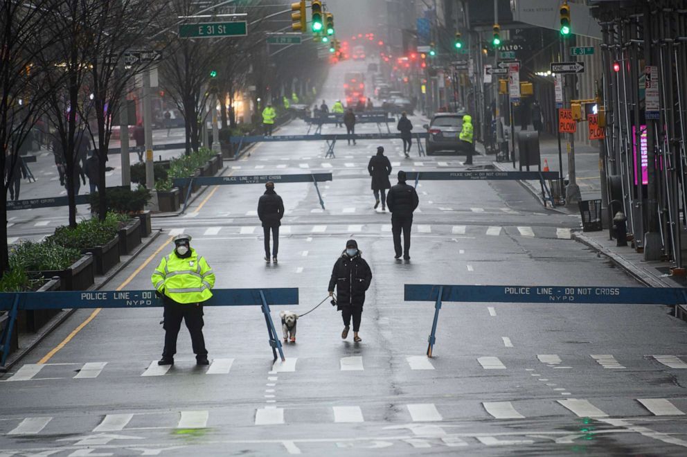 PHOTO: People are seen wearing protective face masks while walking in Park Avenue as part of NYC's "Open Streets", which closes some streets to vehicle traffic to allow more space for pedestrians.