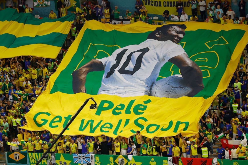 Photo: A Brazilian fan holds up a banner with an image of former player Pele before the World Cup match in Doha, Qatar on December 2, 2022.