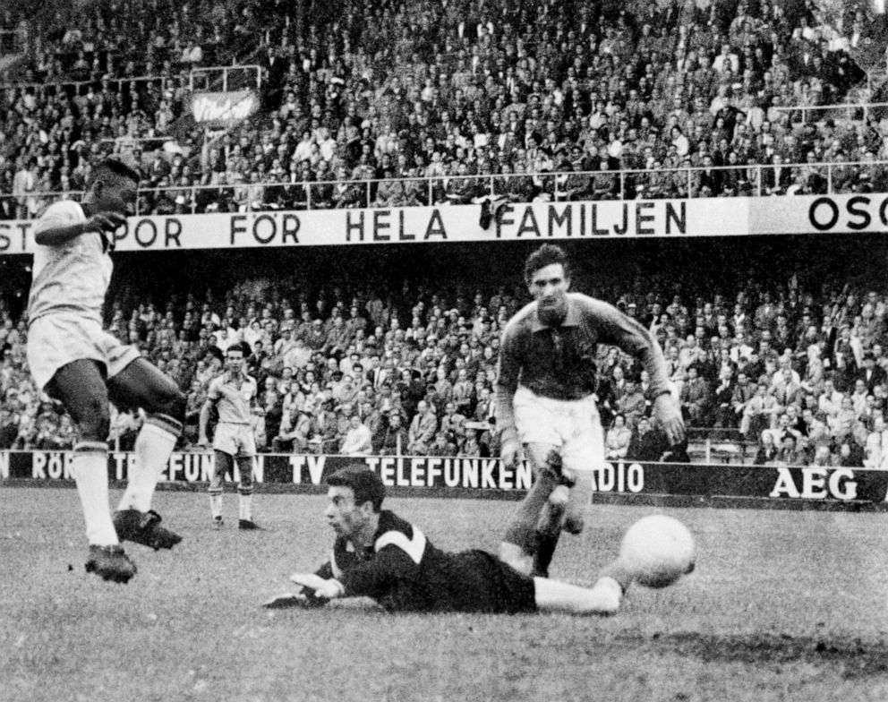PHOTO: Brazil's Pele steers the ball past France goalkeeper Claude Abbes to score his team's third goal during the 1958 World Cup. Brazil won the final match 5-2.