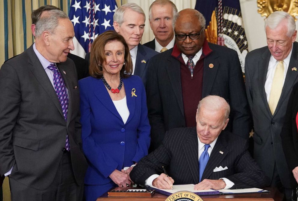 PHOTO: President Joe Biden signs H.R. 3076, the "Postal Service Reform Act of 2022," during a ceremony at the White House, April 5, 2022. 