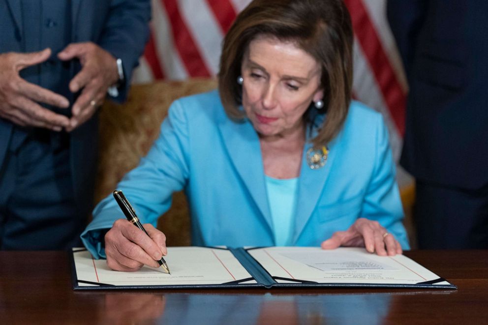 PHOTO: House Speaker Nancy Pelosi of Calif., signs H.R. 55, the "Emmett Till Antilynching Act" which designates lynching as a hate crime under federal law, during a ceremony on Capitol Hill in Washington, March 16, 2022.