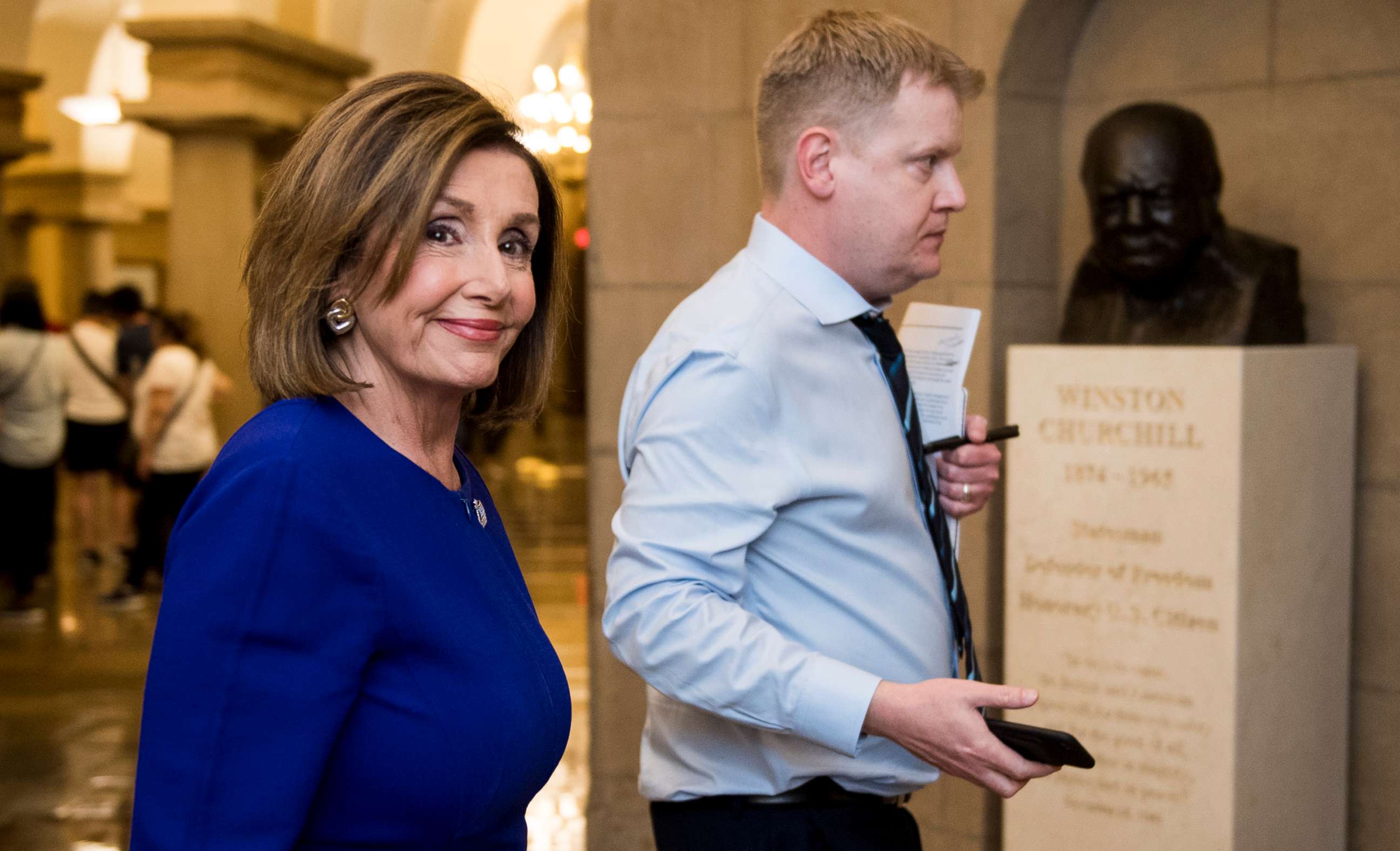 PHOTO: Speaker of the House Nancy Pelosi walks with her Deputy Chief of Staff Drew Hamill past the Sir Winston Churchill bust as she exits the Capitol on Sept. 24, 2019.