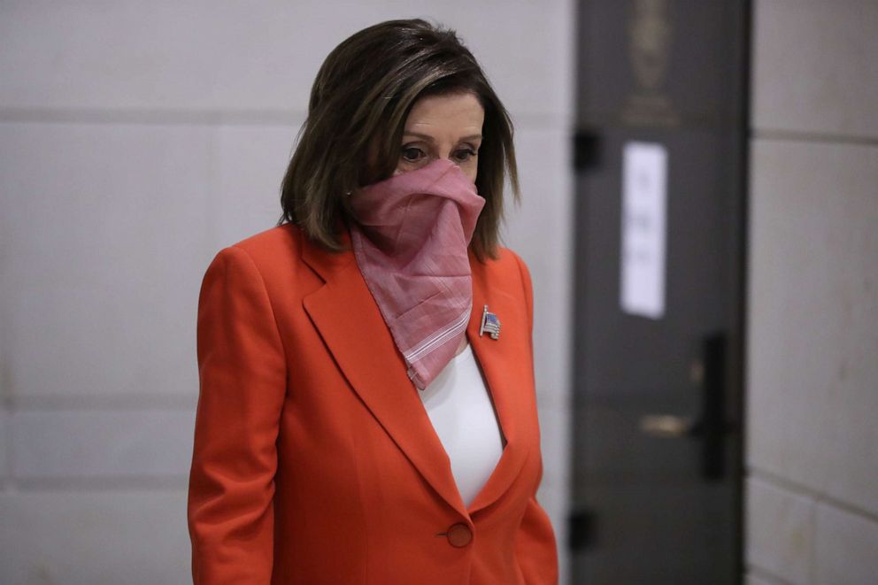 PHOTO: Speaker of the House Nancy Pelosi wears a scarf over her nose and mouth as she arrives for her weekly news conference during the novel coronavirus pandemic at the U.S. Capitol April 24, 2020 in Washington, D.C.