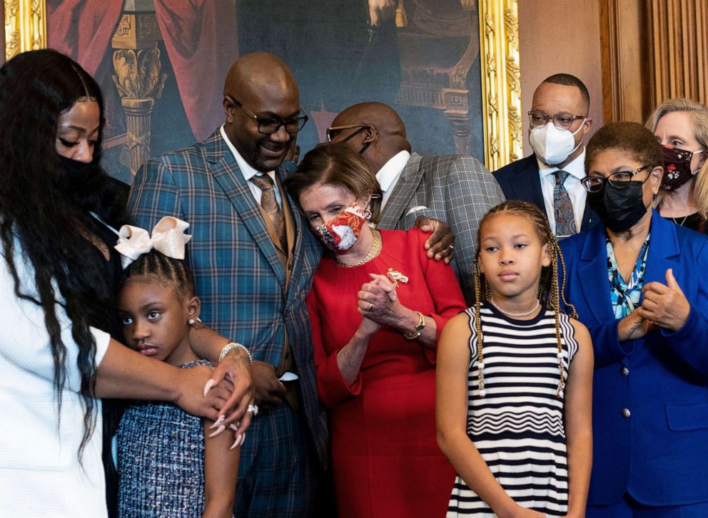 PHOTO: Philonise Floyd, George Floyd's brother, puts his arm around House Speaker Nancy Pelosi as he and other members of the Floyd family meet with Congressional leaders in the Rayburn Room of the US Capitol in Washington on May 25, 2021.