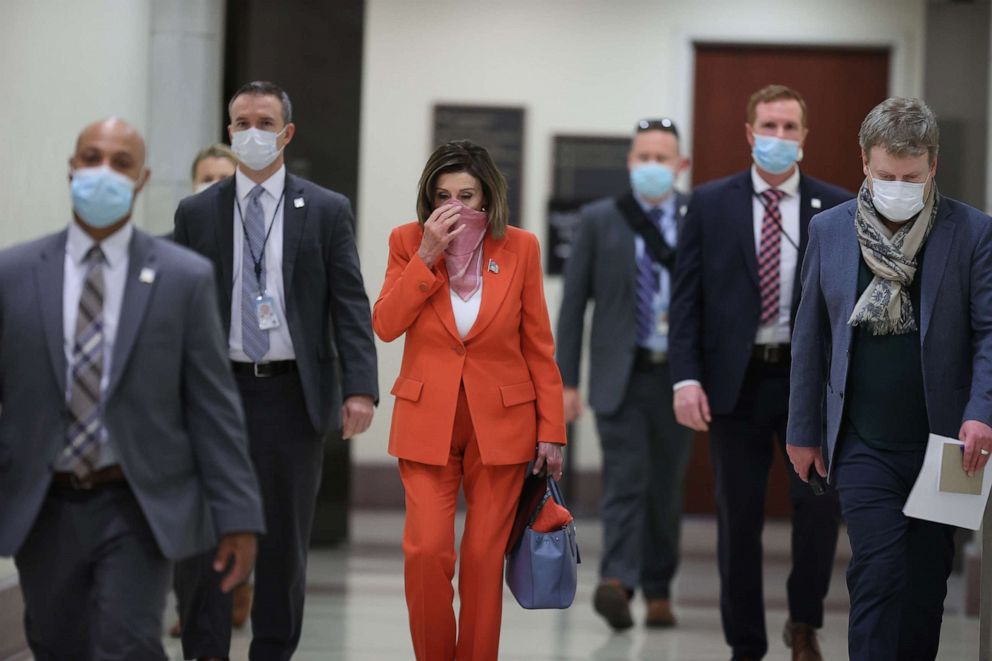 PHOTO: Speaker of the House Nancy Pelosi is surrounded by security and staff as she arrives for her weekly news conference during the novel coronavirus pandemic at the U.S. Capitol April 24, 2020 in Washington, D.C.