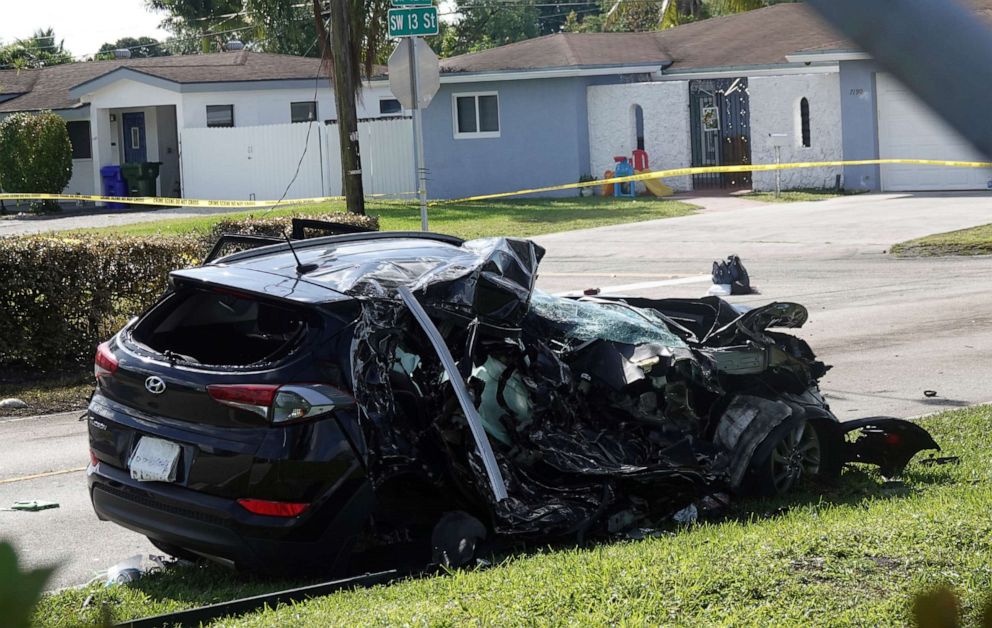 PHOTO: The SUV which was struck by an airplane Monday is seen behind police lines on a residential street near North Perry Airport in Pembroke Pines, March 16, 2021.