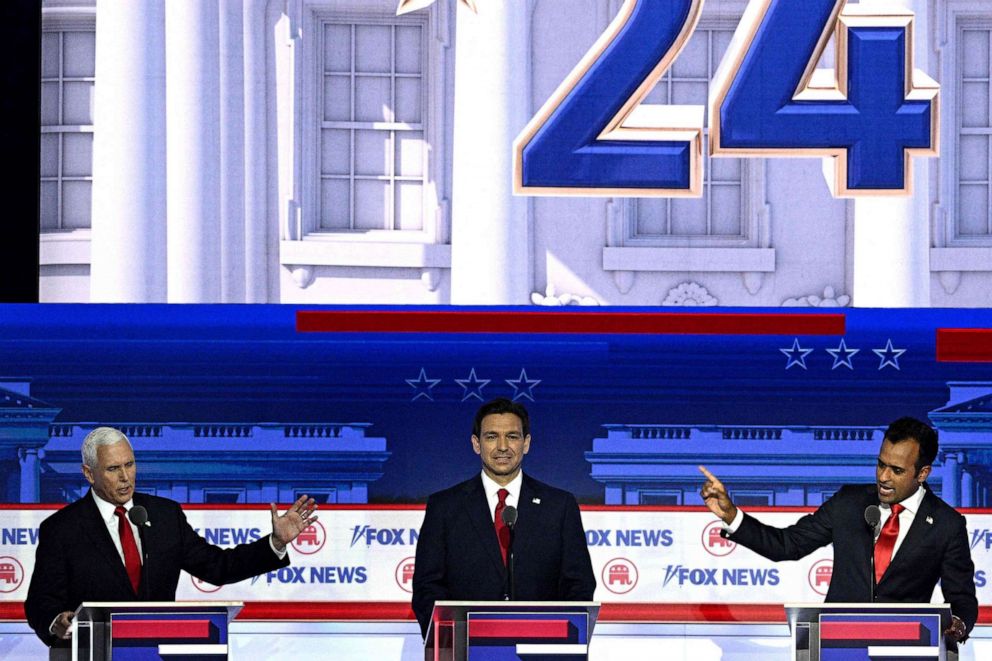 PHOTO: Former Vice President Mike Pence and entrepreneur and author Vivek Ramaswamy gesture toward each other, flanked by Florida Governor Ron DeSantis, during the first Republican Presidential primary debate in Milwaukee, Wisconsin, on Aug. 23, 2023.