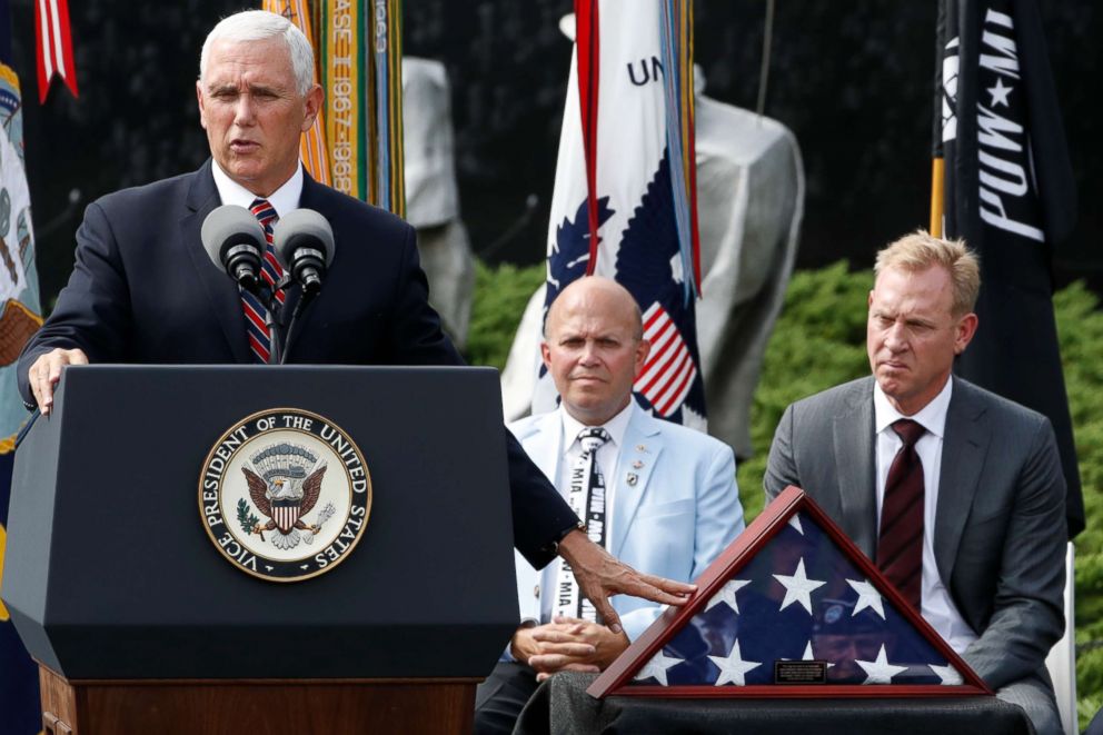 PHOTO: Vice President Mike Pence gestures to an American flag that was used during the return of remains from the Korean War in Hawaii in August 2018, while presenting it to the Korean War Veterans Memorial Foundation, Sept. 20, 2018.
