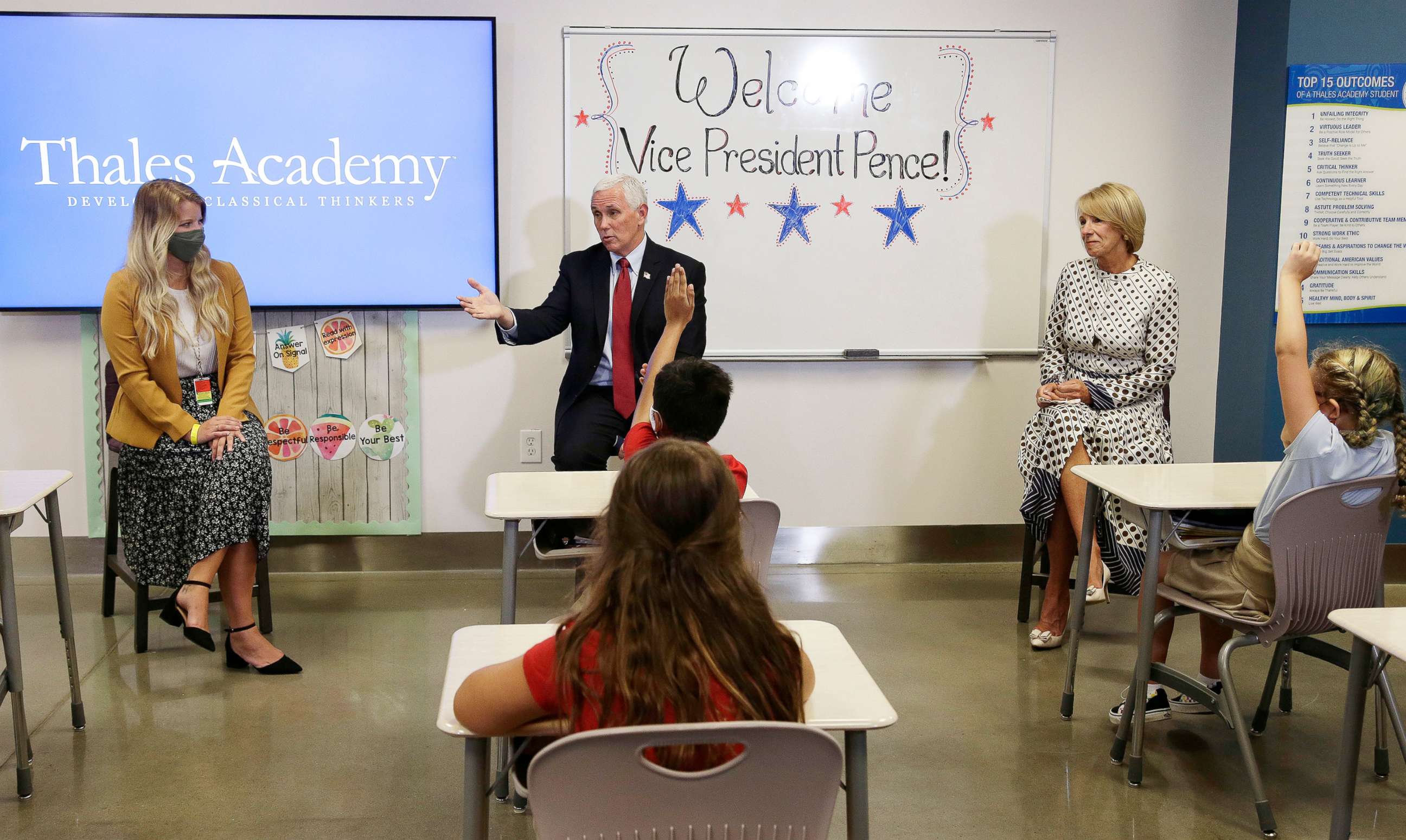 PHOTO: Vice President Mike Pence and Education Secretary Betsy DeVos visit with teacher Allison Combs, left, and her fourth grade students at Thales Academy which reopened to students in Apex, N.C., July 29, 2020.