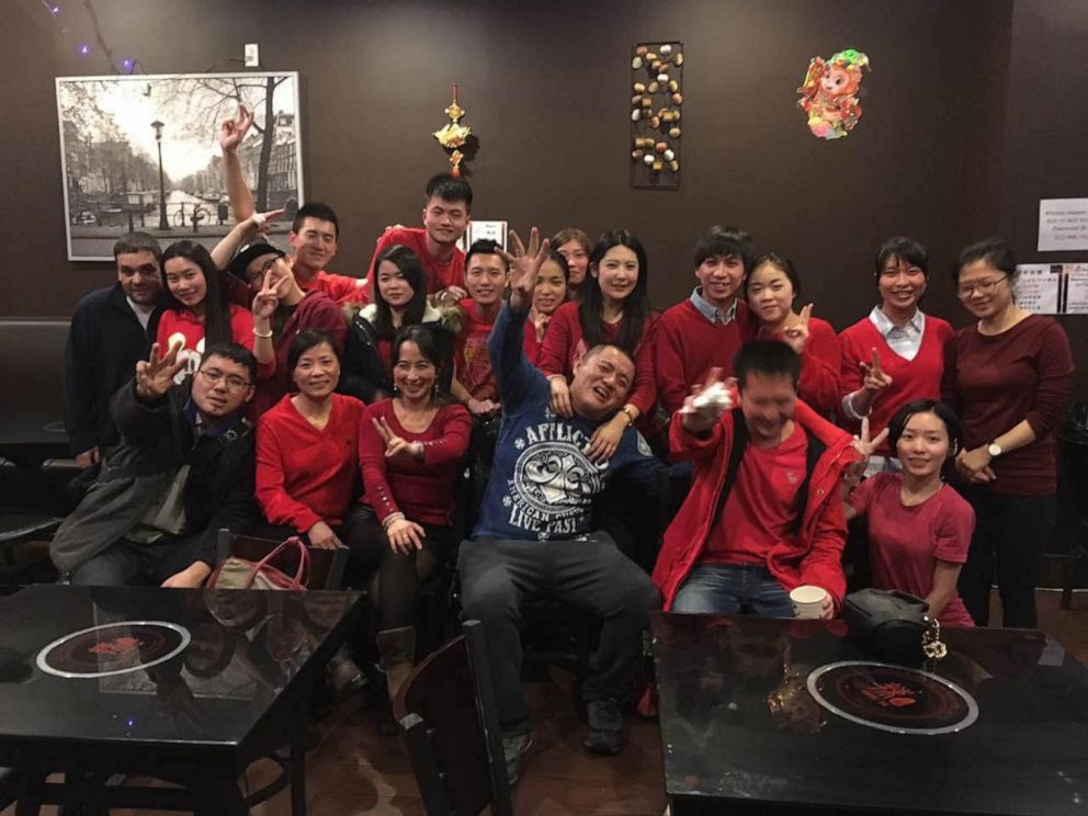 PHOTO: Hai Shian Peng, center, and his staff pose for a group photo before Hou Yi Hot Pot shut down due to the coronavirus pandemic.