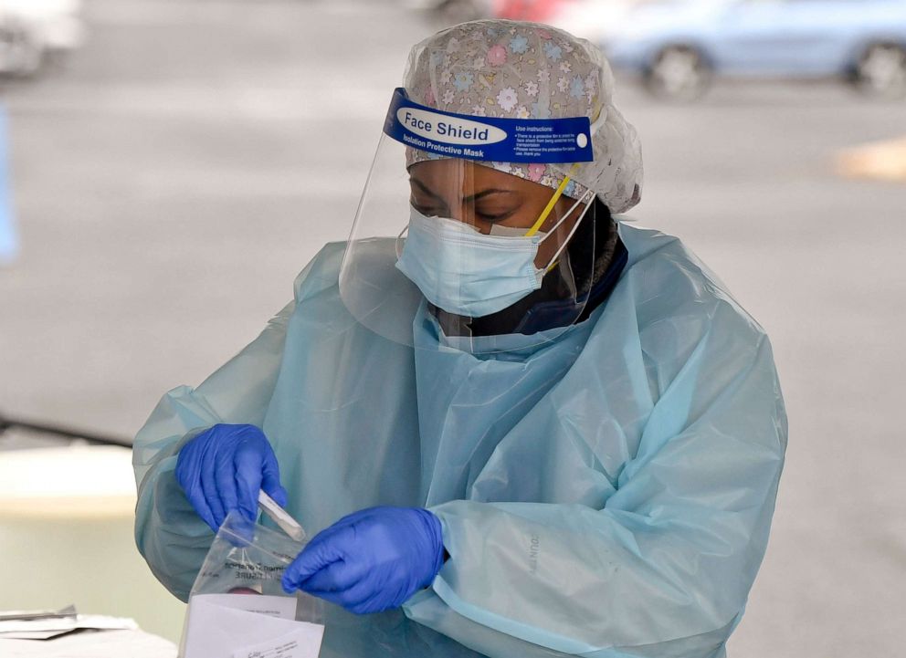 PHOTO: RN Treva Rivers puts a specimen into a bag after administering a COVID-19 test in Reading, Oct. 13, 2020.