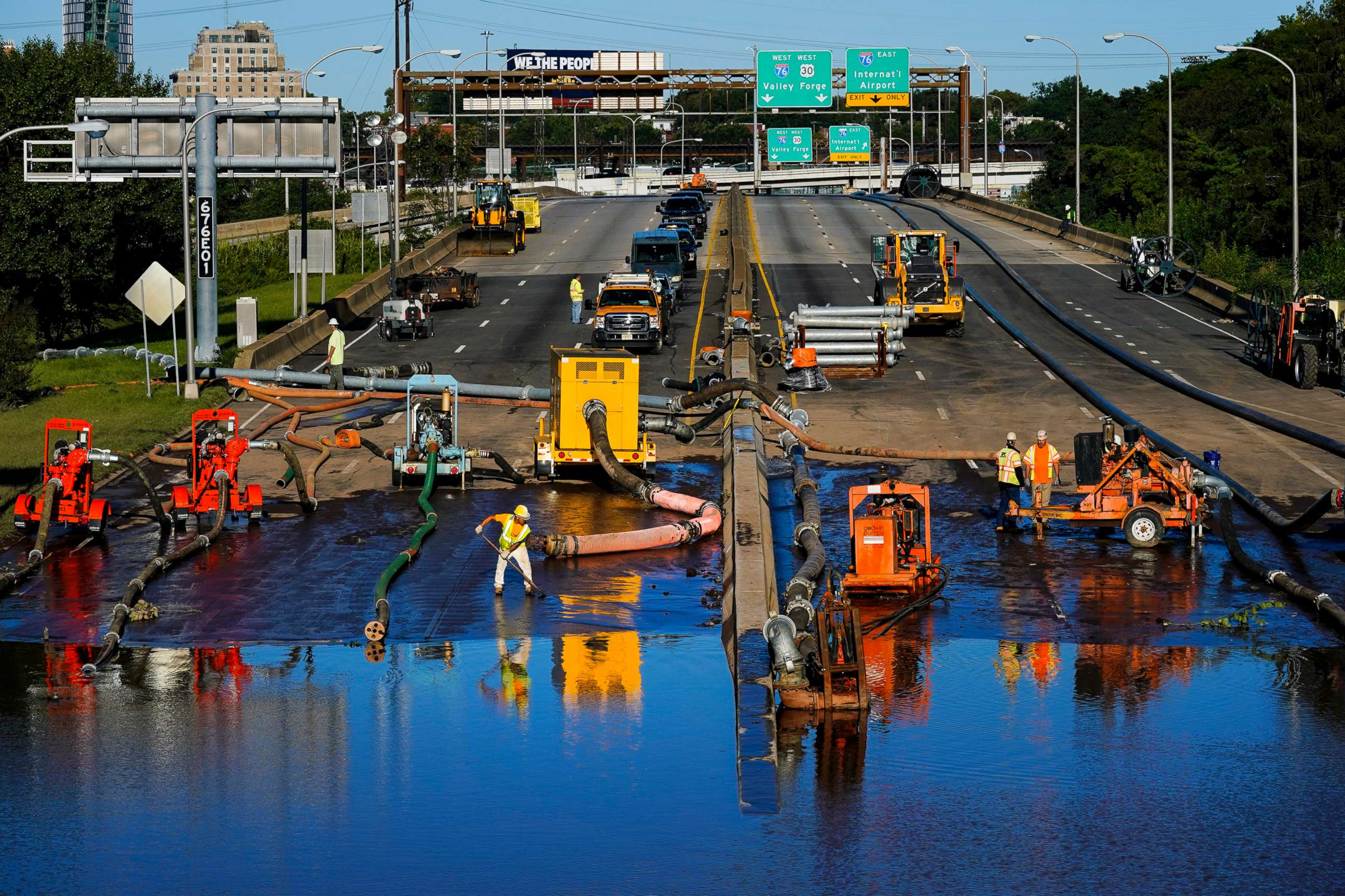 PHOTO: Workers pump water from a flooded section of Interstate 676 in Philadelphia Sept. 3, 2021.
