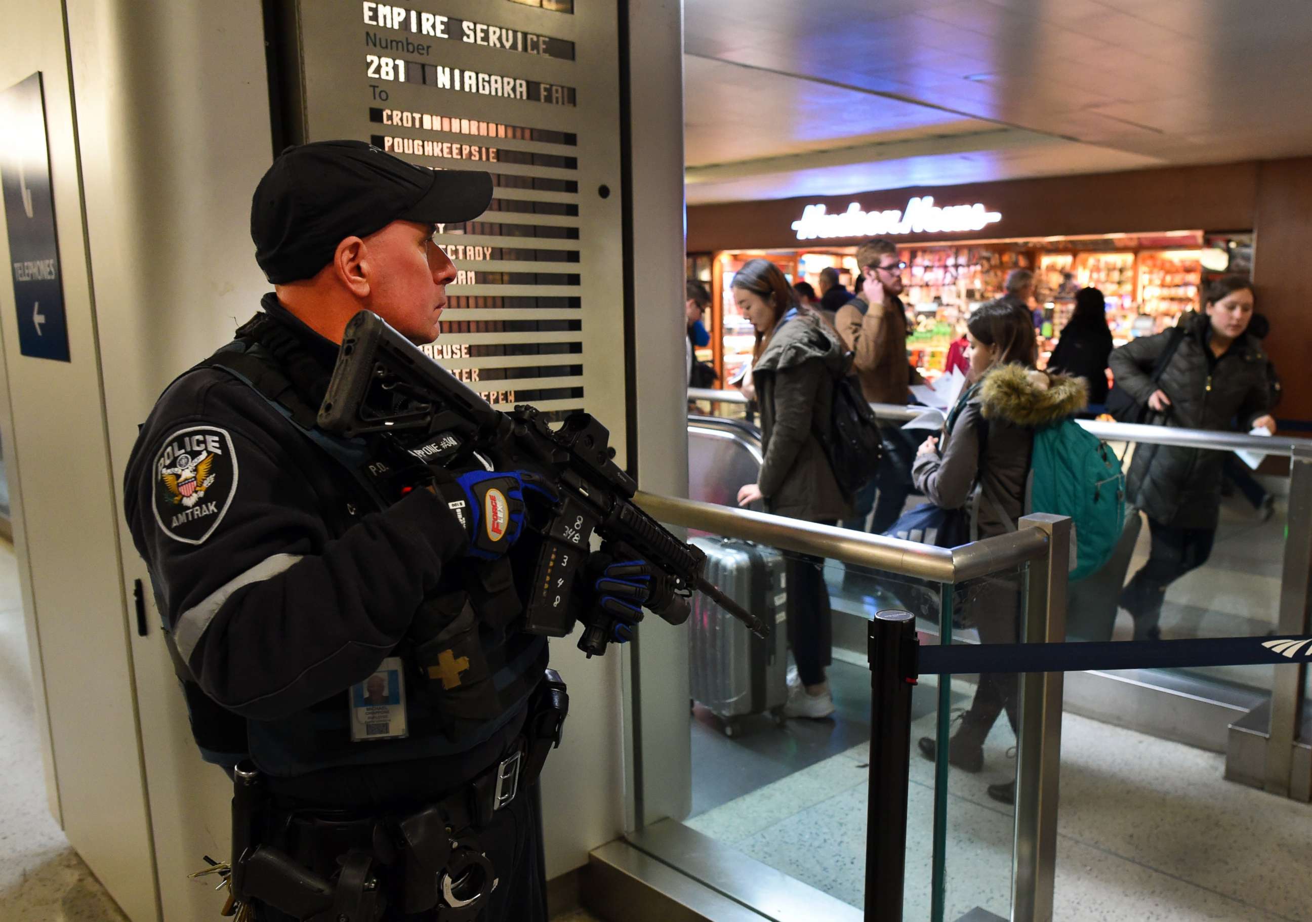 PHOTO: An Amtrak Police officer watches passengersas they board a train at Penn Station on Nov. 24, 2015 in New York.