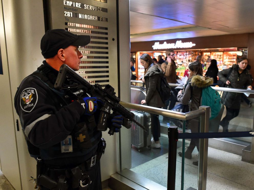 PHOTO: An Amtrak Police officer watches passengersas they board a train at Penn Station on Nov. 24, 2015 in New York.
